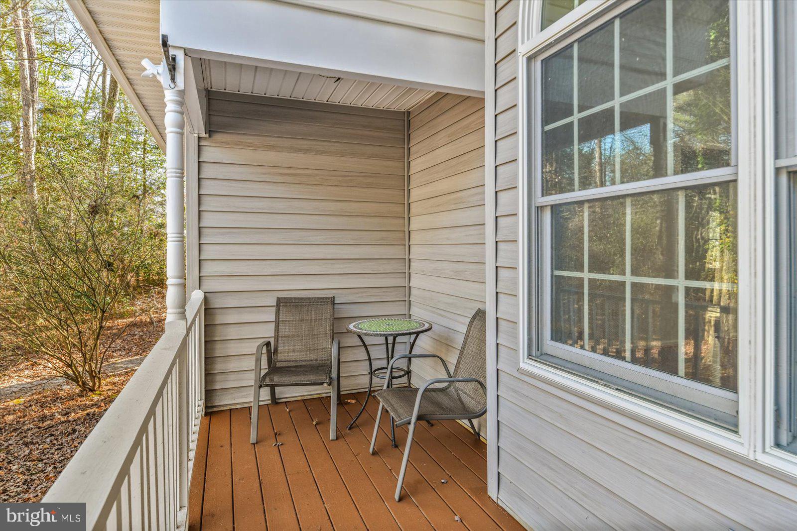 68 Falcon Bridge Road Berlin, MD 21811 - Photo 49 of 71 a balcony with table and chairs and wooden floor