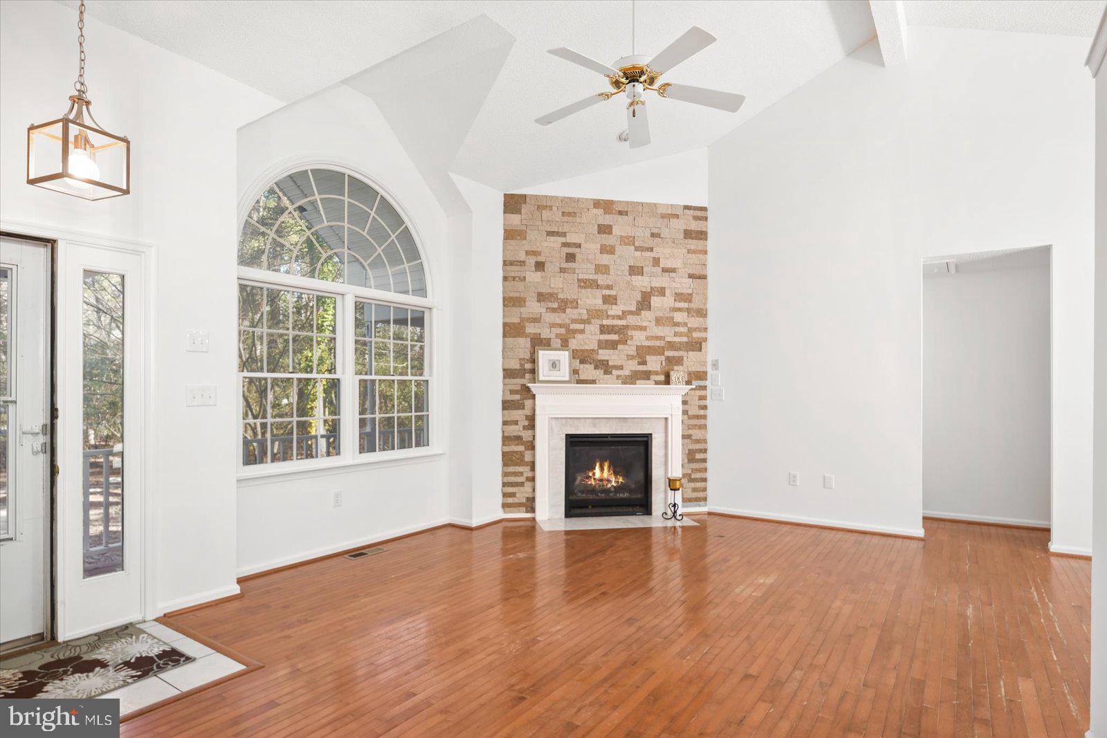 68 Falcon Bridge Road Berlin, MD 21811 - Photo 5 of 71 a view of an empty room with wooden floor fireplace and a window