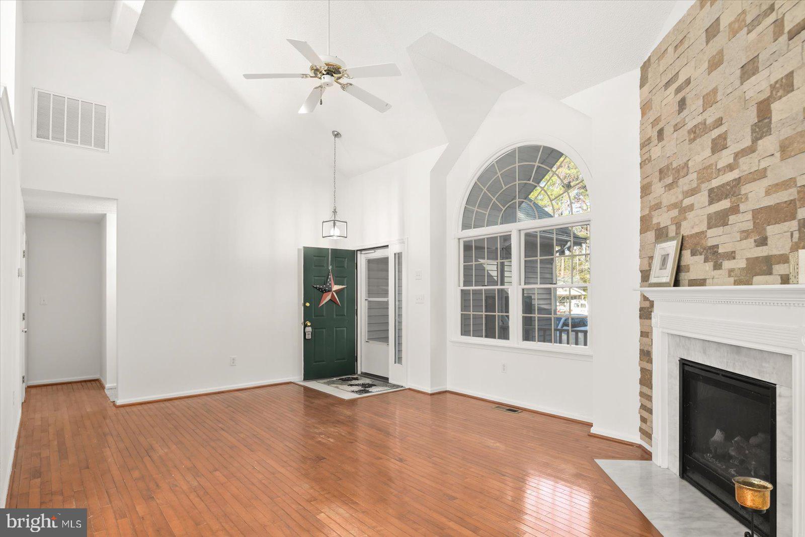 68 Falcon Bridge Road Berlin, MD 21811 - Photo 6 of 71 a view of an empty room with a fireplace and a window