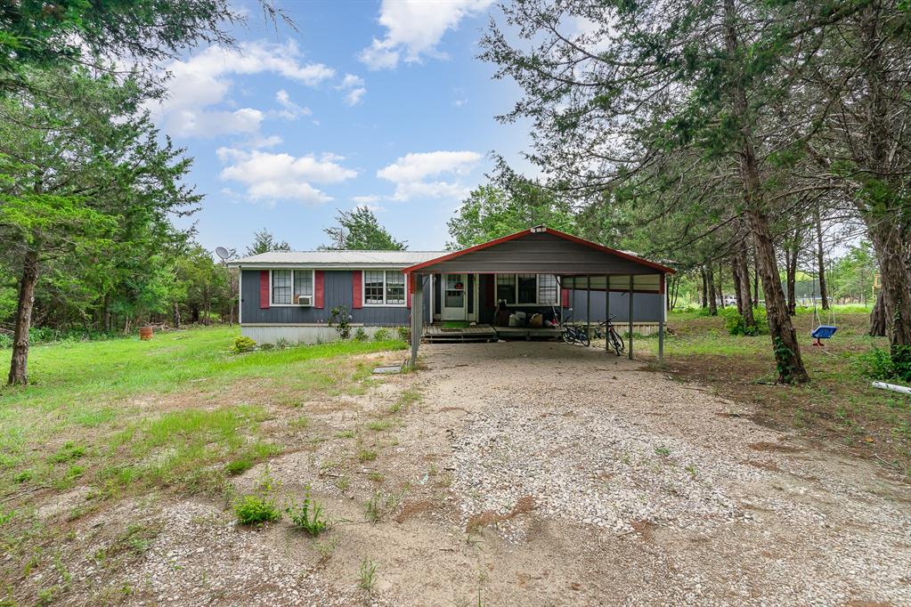 7903 Reata Road Quinlan, TX 75474 - Photo 1 of 1 a front view of house with yard and green space