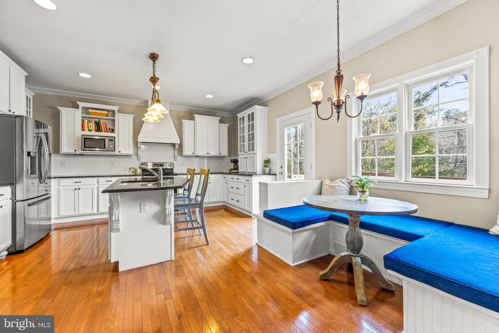 776 Snodgrass Road Crownsville, MD 21032 - Photo 25 of 82 a kitchen with stainless steel appliances kitchen island granite countertop a table chairs and a chandelier