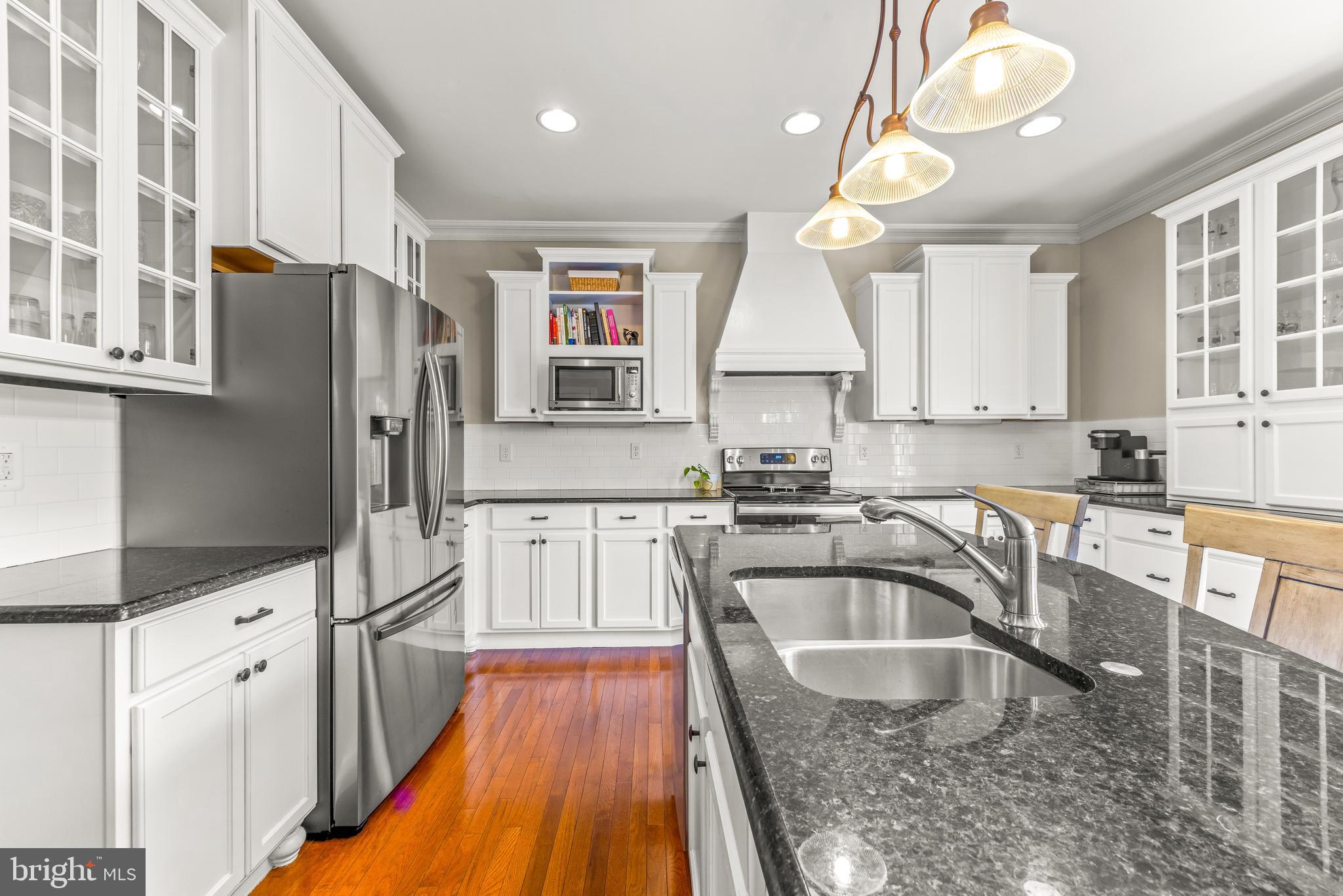 776 Snodgrass Road Crownsville, MD 21032 - Photo 32 of 82 a kitchen with granite countertop a sink a counter space appliances and cabinets