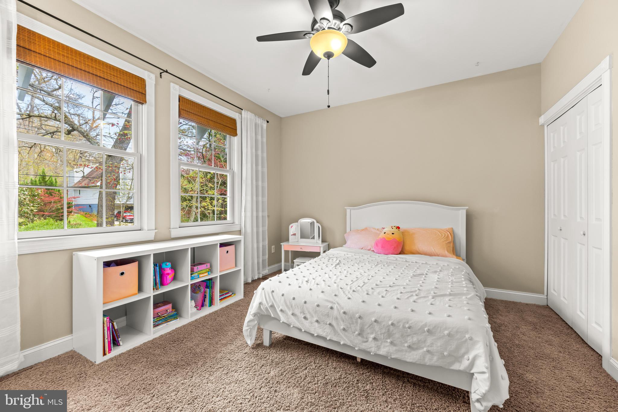 776 Snodgrass Road Crownsville, MD 21032 - Photo 39 of 82 a bedroom with a bed a baby crib and a book shelf