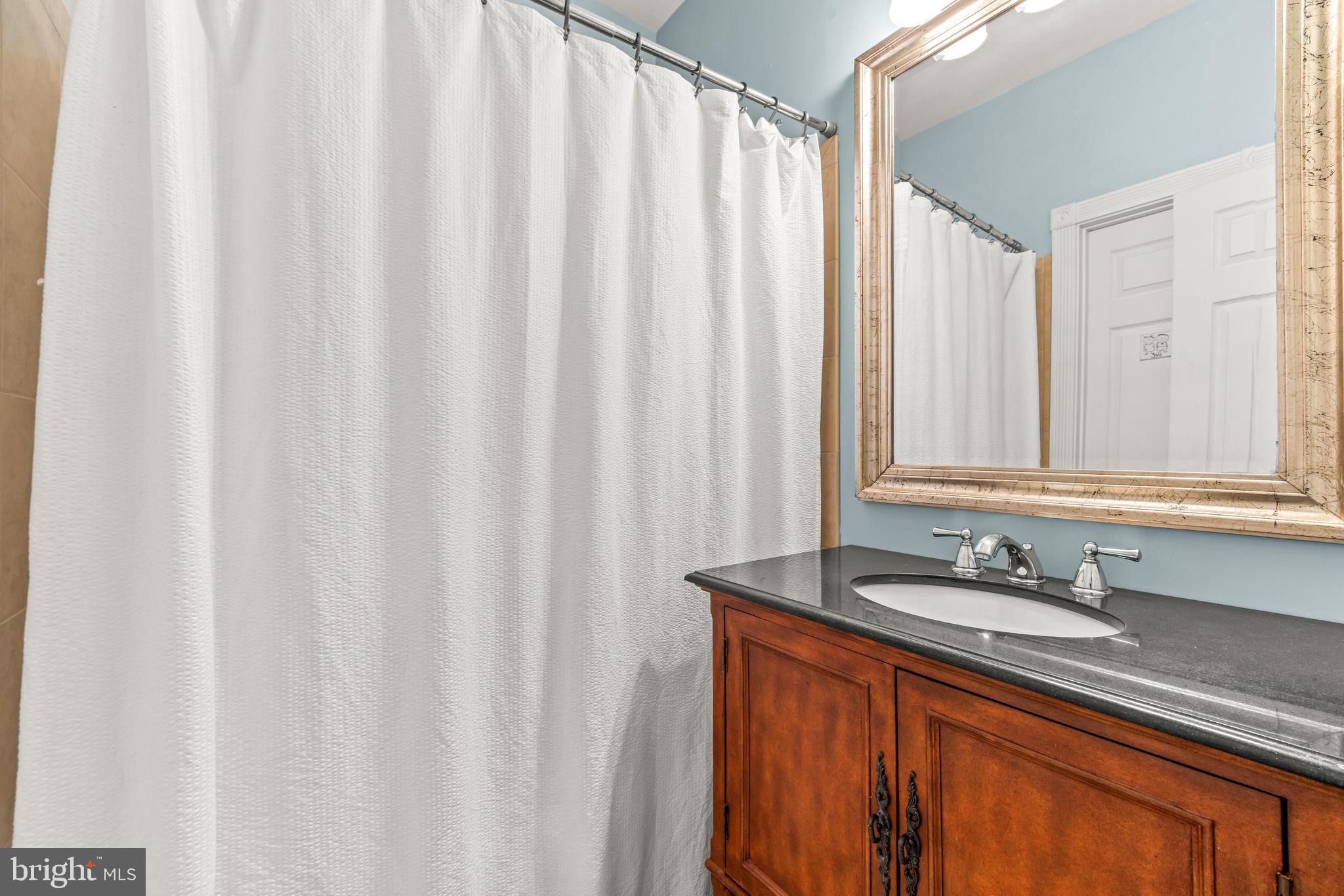 776 Snodgrass Road Crownsville, MD 21032 - Photo 44 of 82 a bathroom with a sink and a mirror