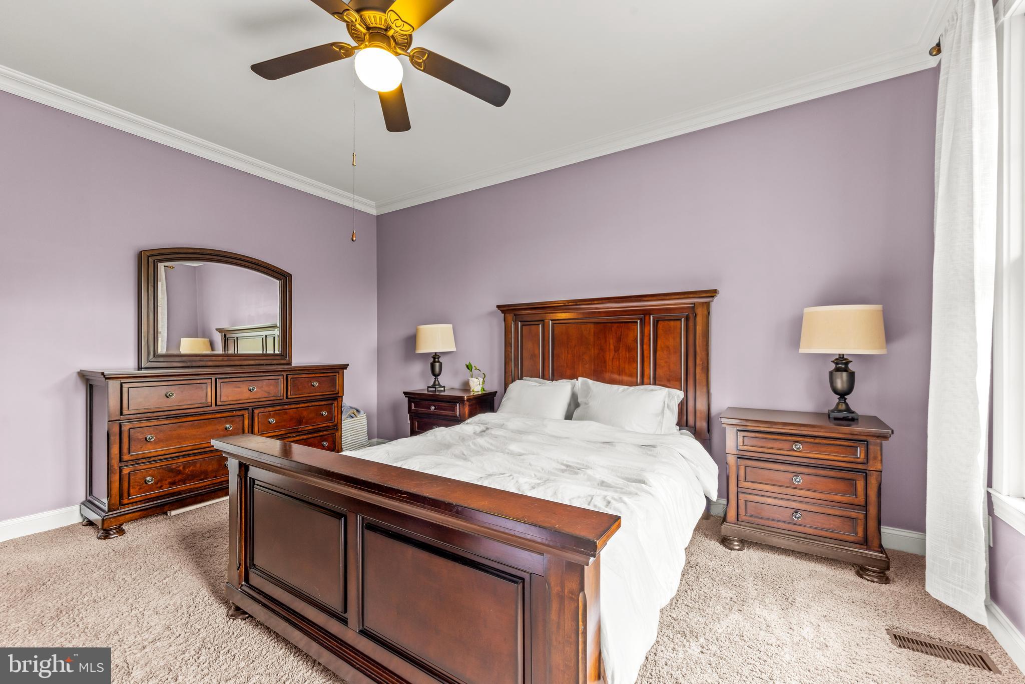 776 Snodgrass Road Crownsville, MD 21032 - Photo 50 of 82 a bedroom with a bed and a chandelier