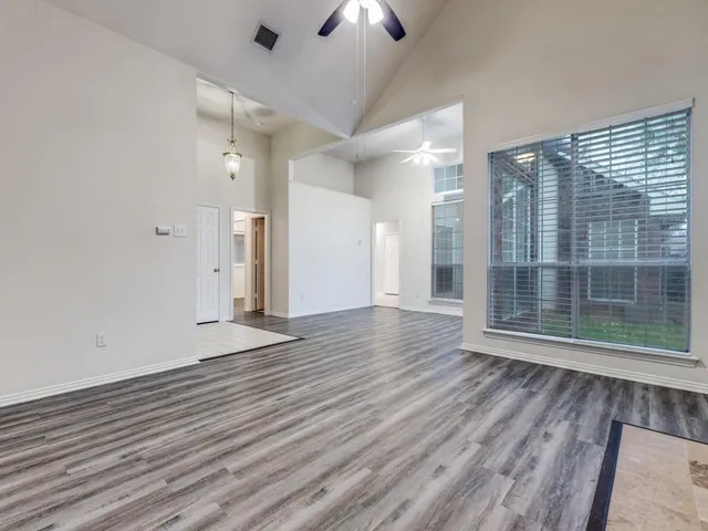 wooden floor in an empty room with a window