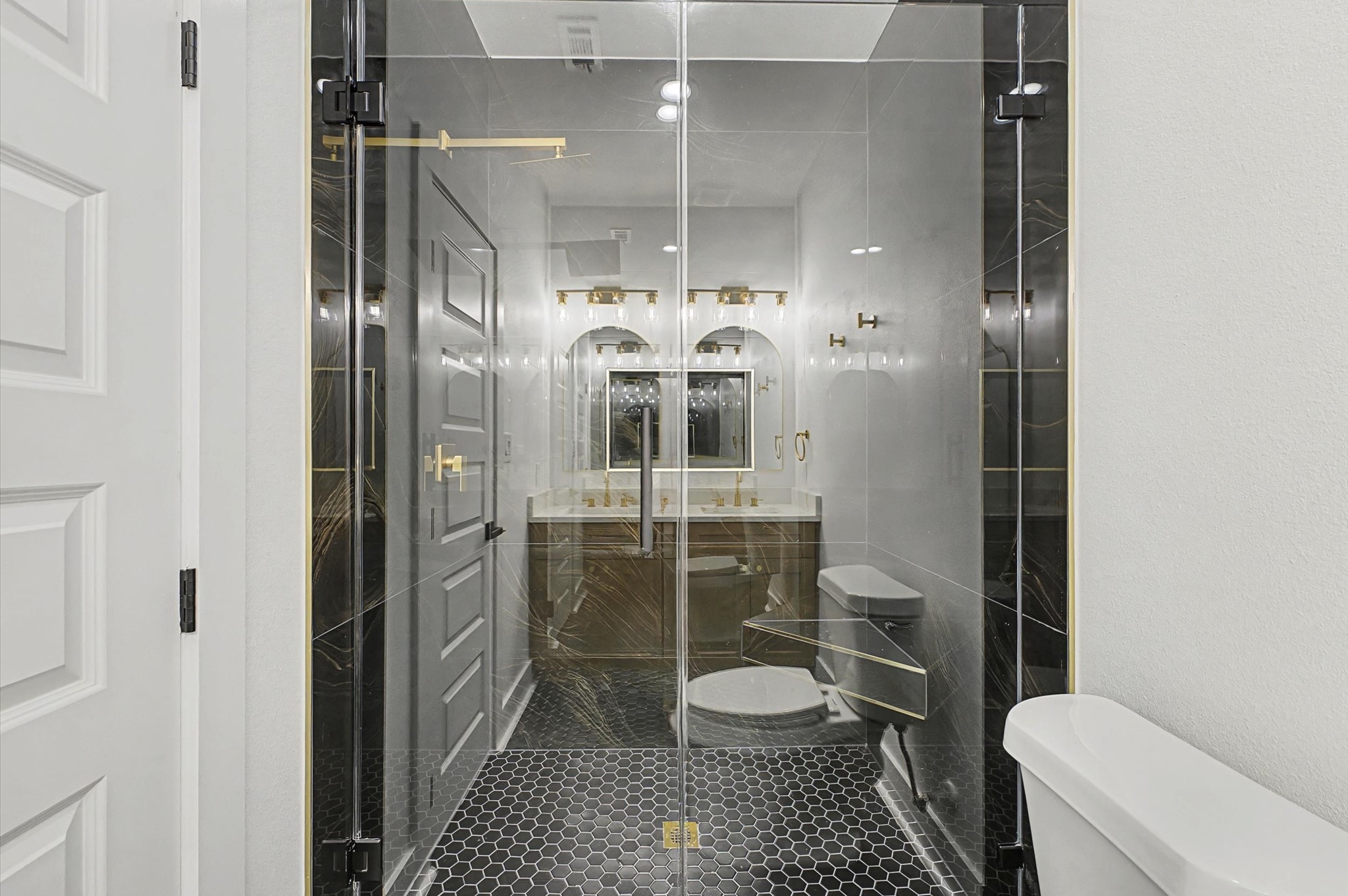 9214 Madera Road Houston, TX 77078 - Photo 11 of 24 a bathroom with a toilet a sink and shower