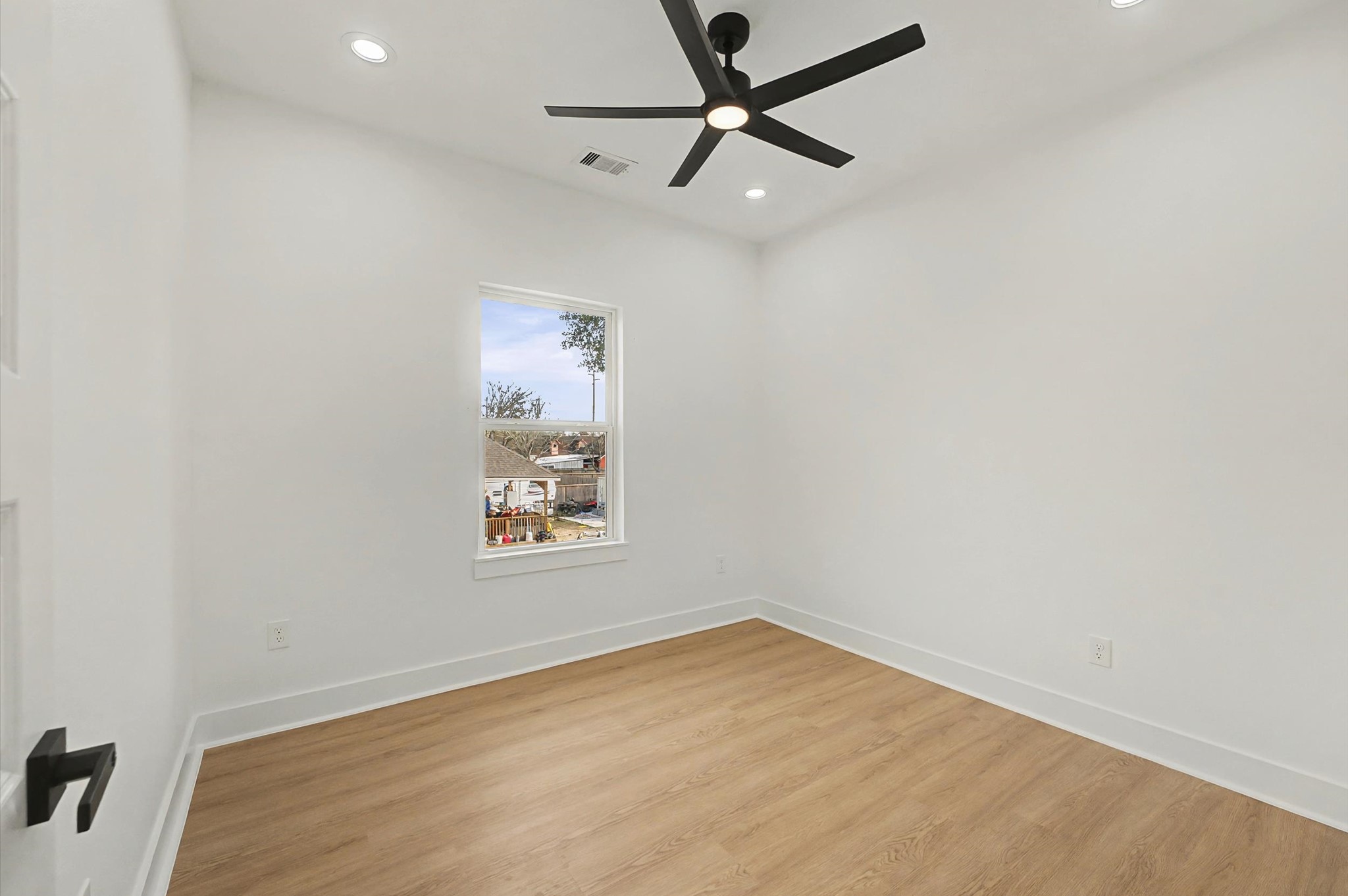 9214 Madera Road Houston, TX 77078 - Photo 17 of 24 an empty room with a window and a fan