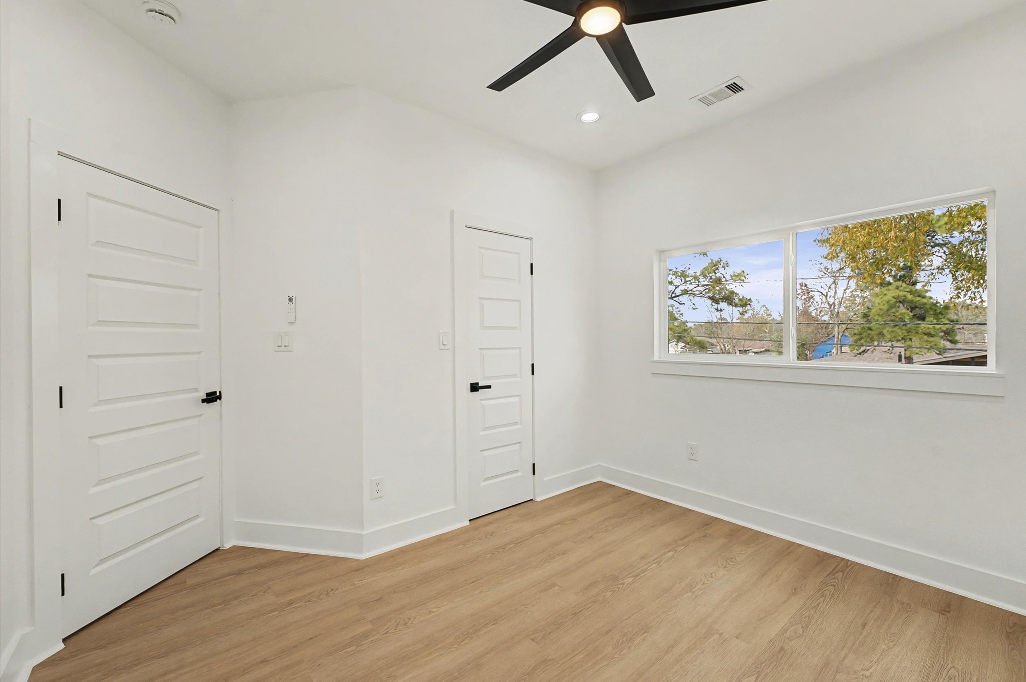 9214 Madera Road Houston, TX 77078 - Photo 18 of 24 a view of empty room with wooden floor and window