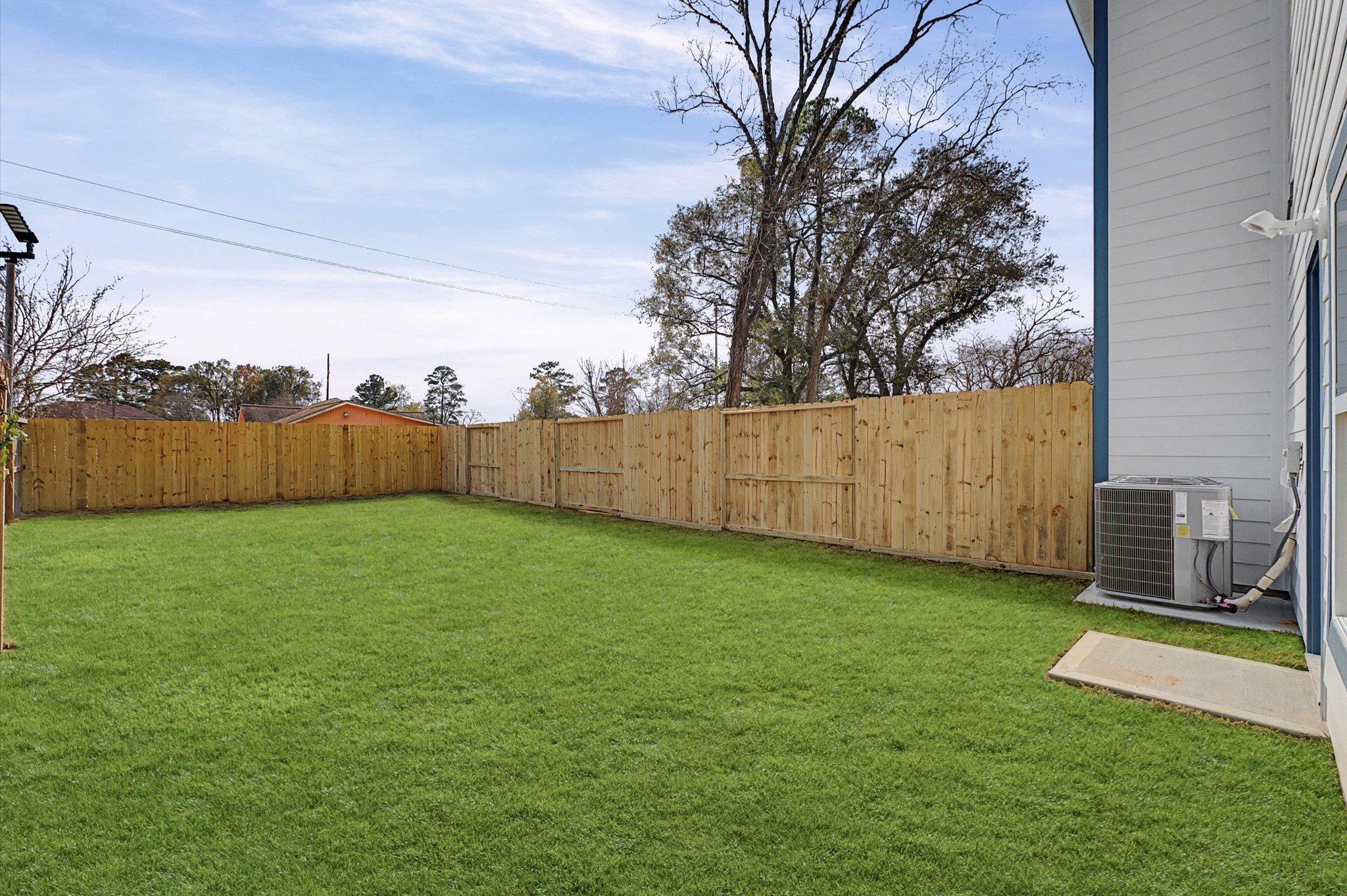 9214 Madera Road Houston, TX 77078 - Photo 20 of 24 a view of a backyard with grass and wooden fence