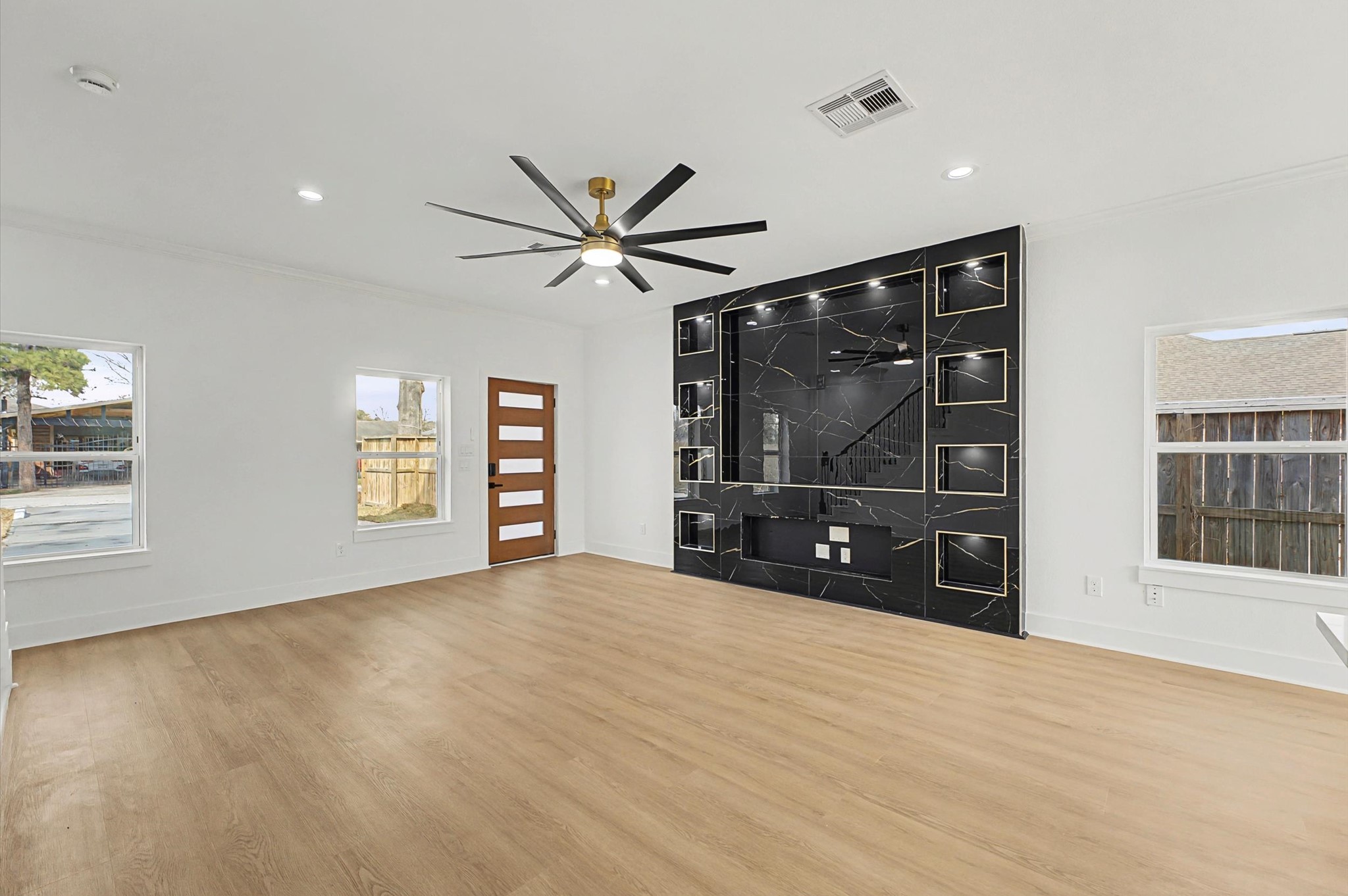 9214 Madera Road Houston, TX 77078 - Photo 9 of 24 a view of an empty room with a window and wooden floor