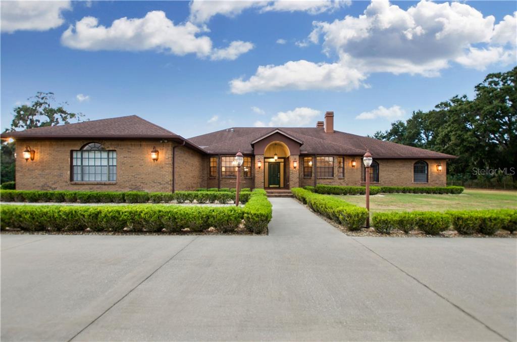908 Telfair Road Brandon, FL 33510 - Photo 1 of 1 a front view of a house with a garden