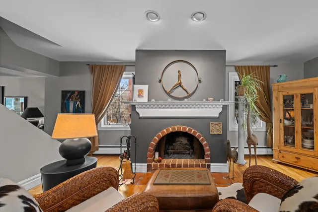 a living room with furniture a chandelier and a large window