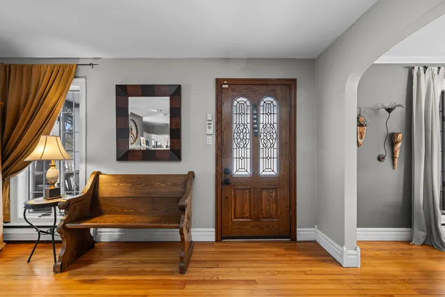a spacious bedroom with a bed a couch and a large window