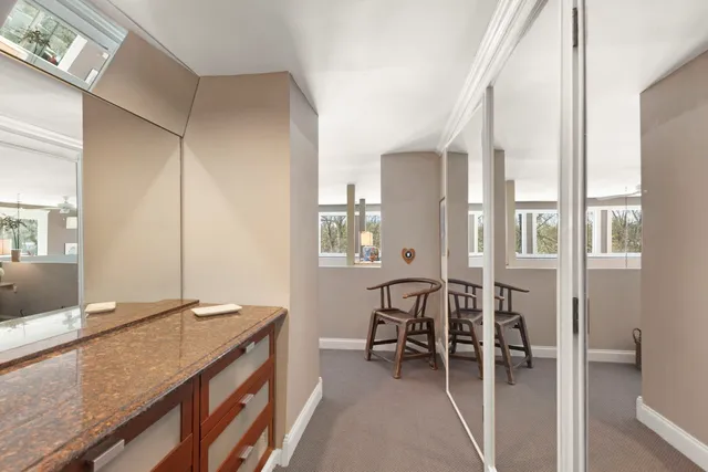 a view of a house with snow on the side of road