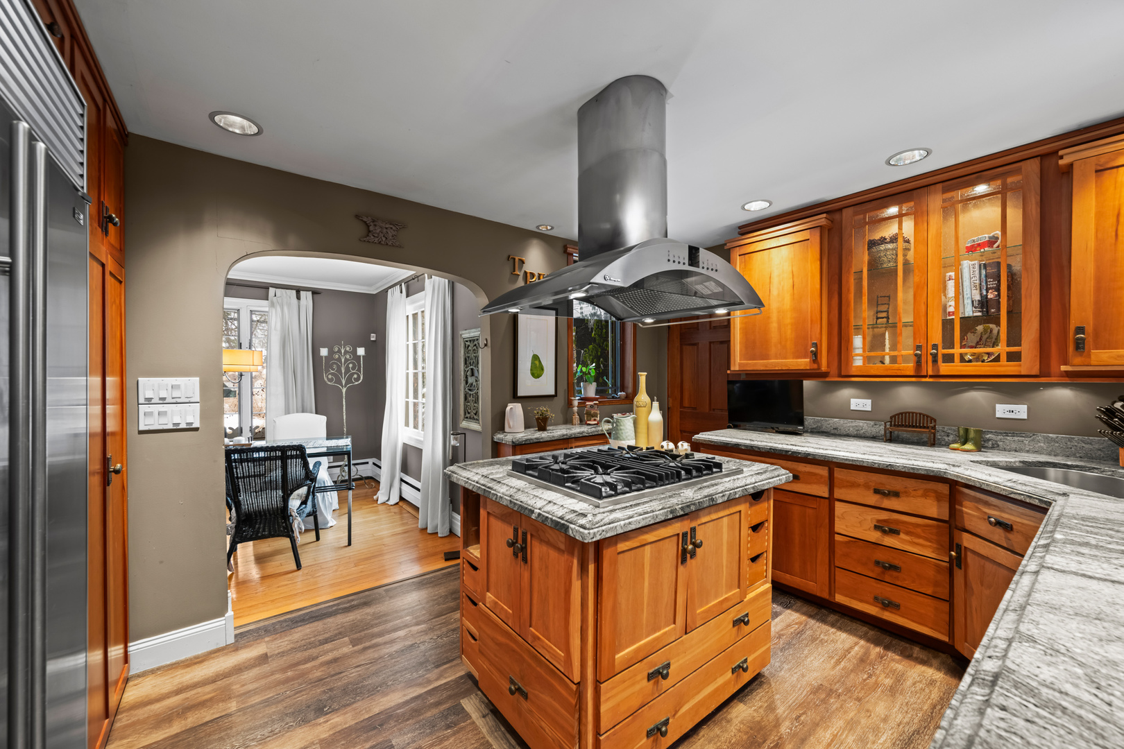 108 North Wheeling Road Prospect Heights, IL 60070 - Photo 5 of 54 a kitchen with stainless steel appliances granite countertop a stove a sink dishwasher and a dining table with wooden cabinet