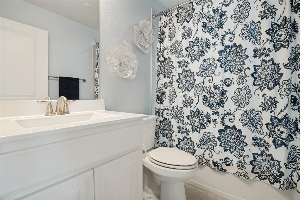 388 Bethany Road Sunnyvale, TX 75182 - Photo 29 of 40 Bathroom featuring a white vanity with an integrated sink, brushed nickel faucet, and a large mirror