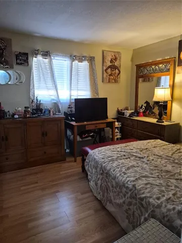 a bed room with a bed and a television