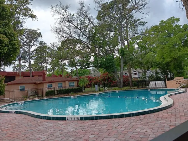 a view of a house with a yard and sitting area