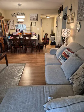 a living room with furniture and a dining table