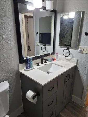 a bathroom with a double vanity sink and a mirror