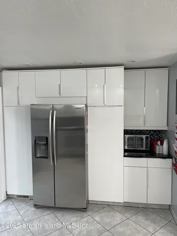 a kitchen with refrigerator and cabinets