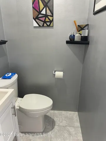 a white toilet sitting next to a bathroom sink