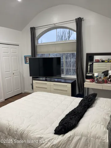 a bedroom with a bed and a fireplace