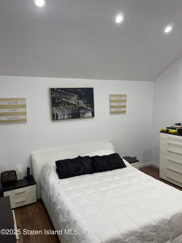 a bedroom with a bed and gym equipment