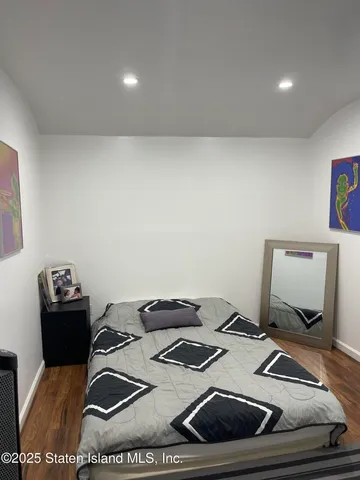a view of a patio with couches chairs and wooden floor