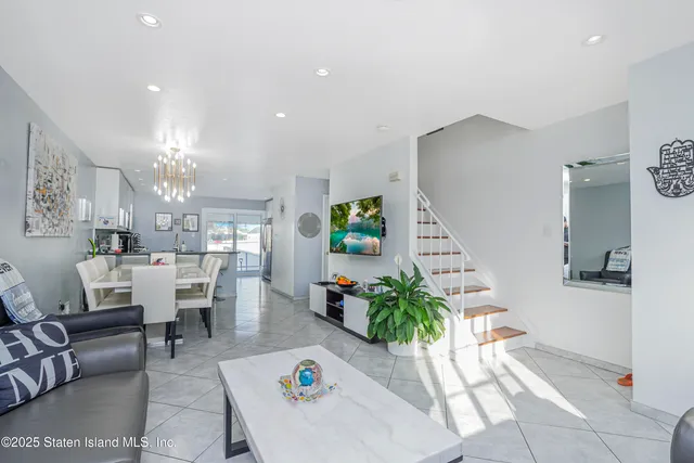 a living room with furniture and a chandelier