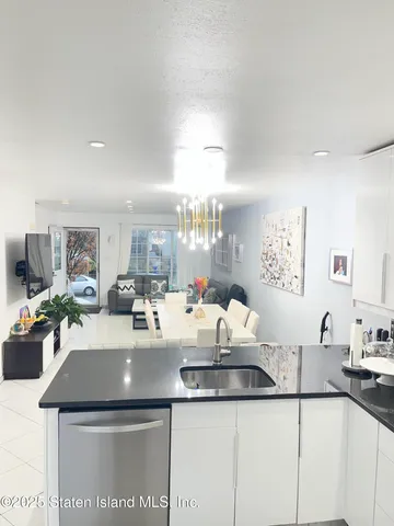 a kitchen with a sink a stove and chairs