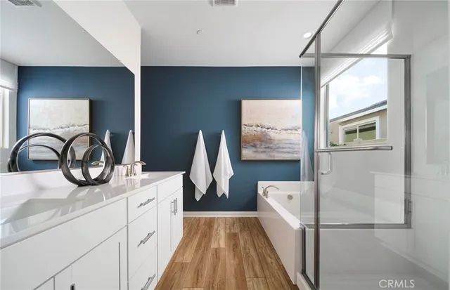 a bathroom with a sink a bathtub and a window