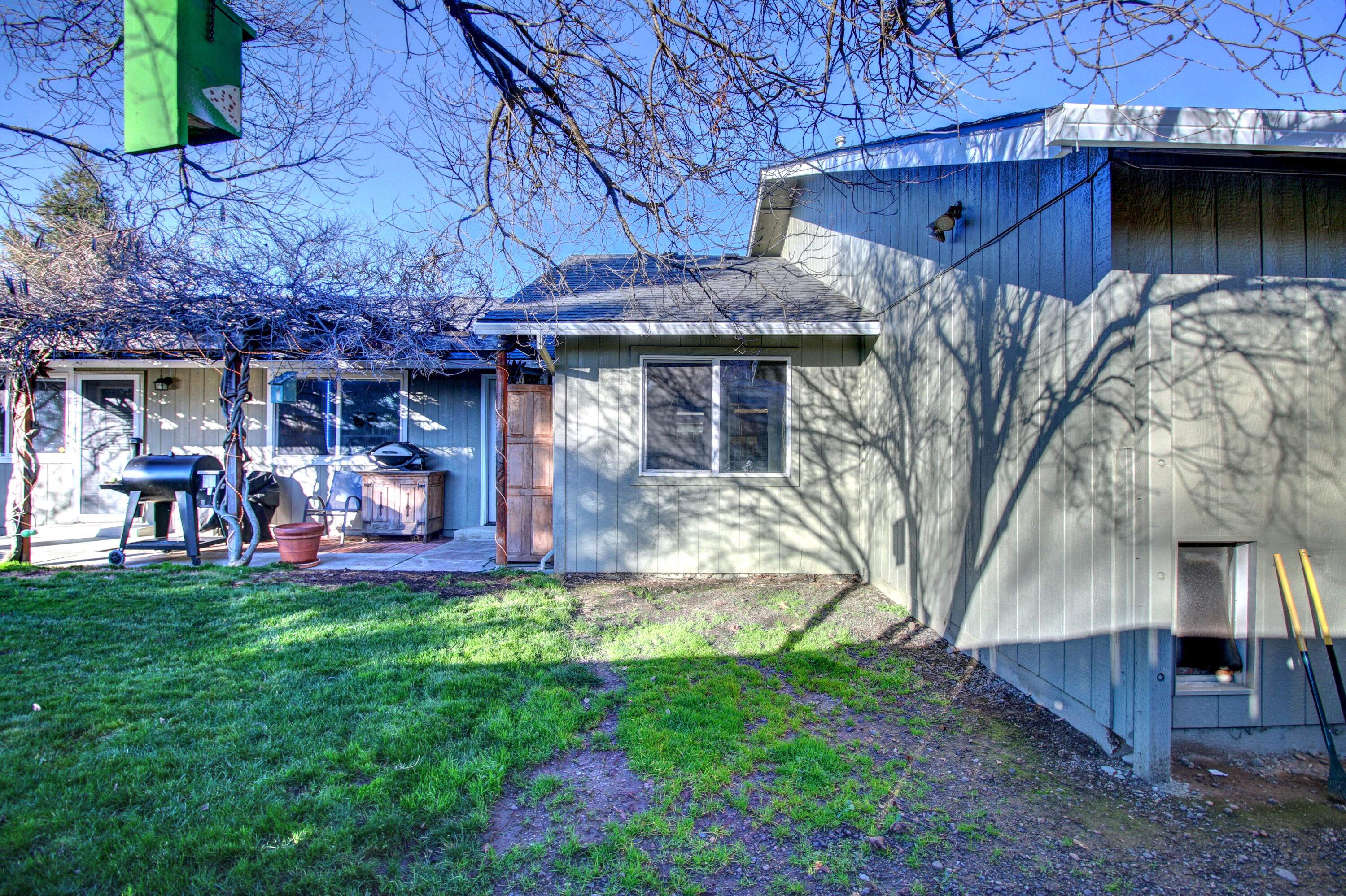 2683 Merriman Road Medford, OR 97501 - Photo 17 of 23 a front view of a house with a garden and sitting area