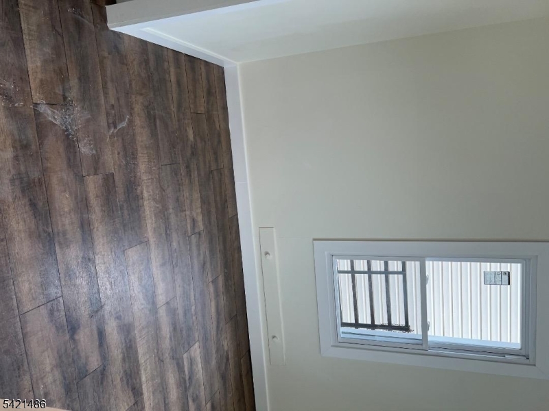 227 Palmer Street, Unit 1 Elizabeth, NJ 07202 - Photo 2 of 7 a view of wooden floor and a window in a room