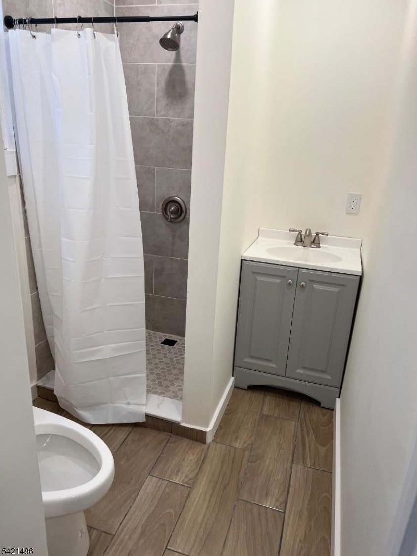 227 Palmer Street, Unit 1 Elizabeth, NJ 07202 - Photo 6 of 7 a bathroom with a sink a toilet and shower