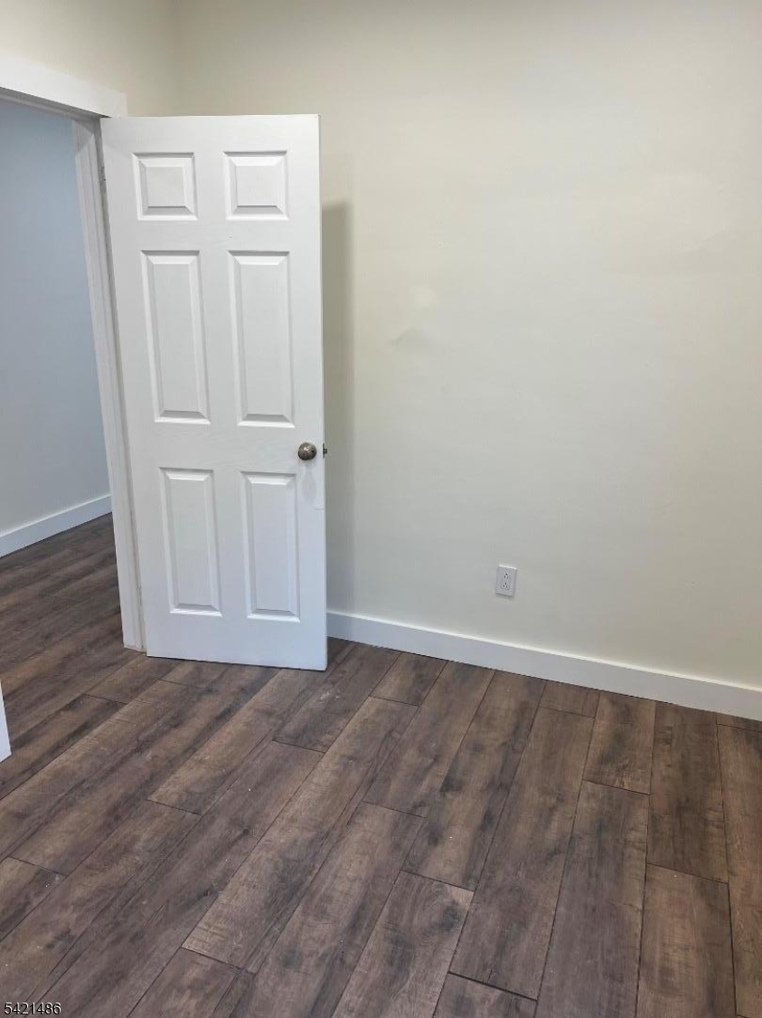 227 Palmer Street, Unit 1 Elizabeth, NJ 07202 - Photo 7 of 7 a view of an empty room with wooden floor