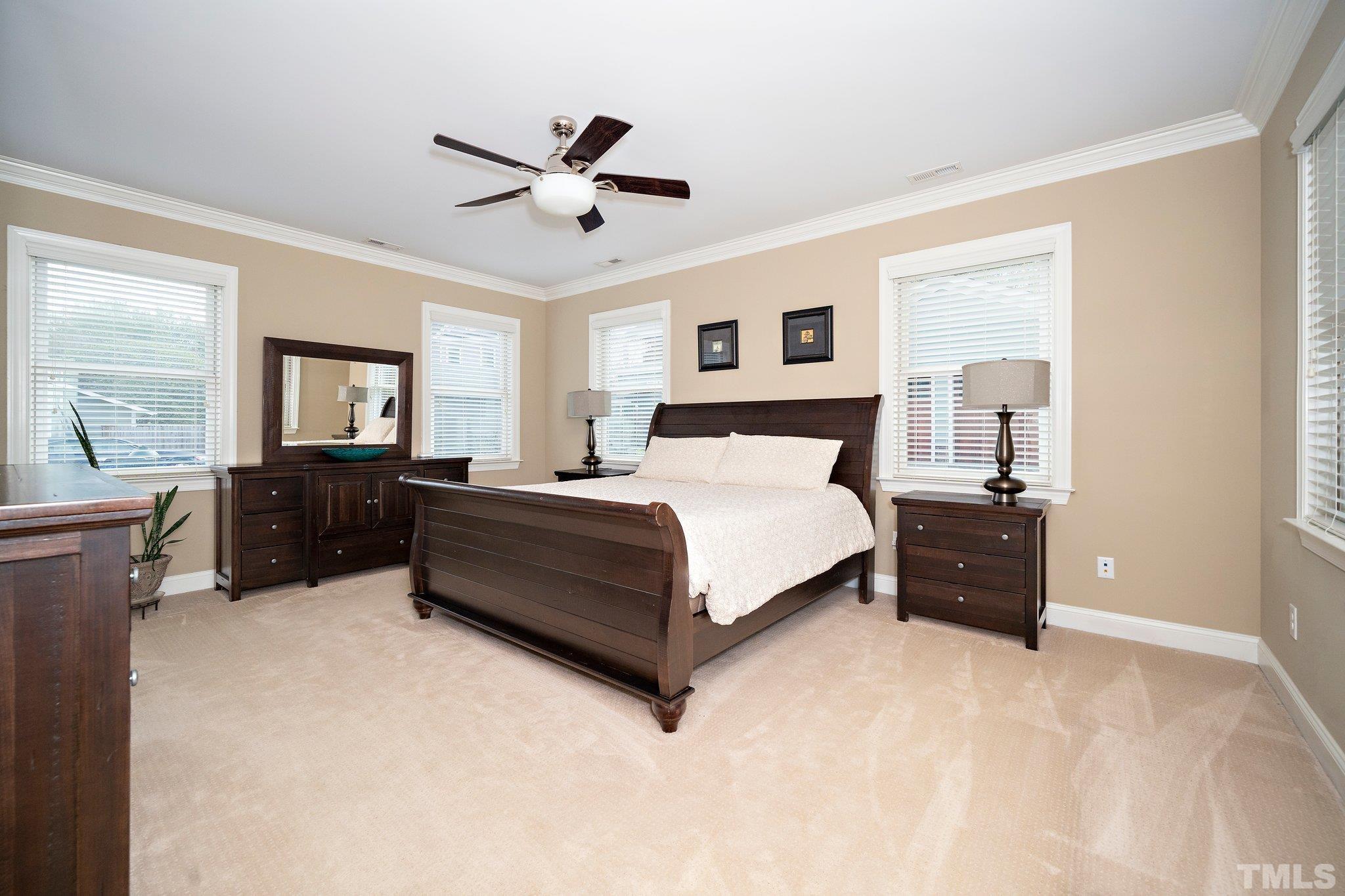 606 North Boundary Street Raleigh, NC 27604 - Photo 8 of 16 a bedroom with a large bed and a chandelier