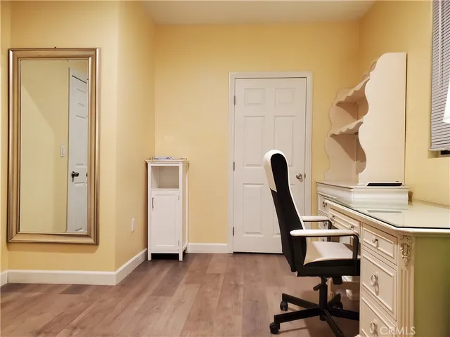 a bedroom with a bed and a mirror