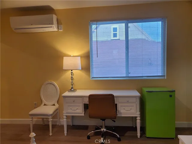 a bedroom with a bed a desk and chair