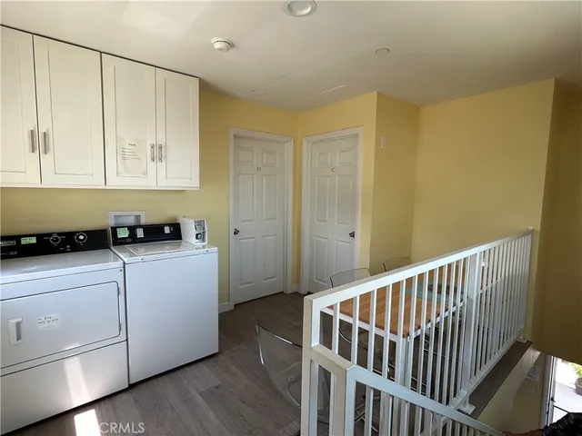 a hallway with furniture a stove top oven and wooden floor