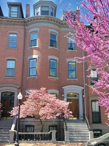 a front view of a multi story building with yard
