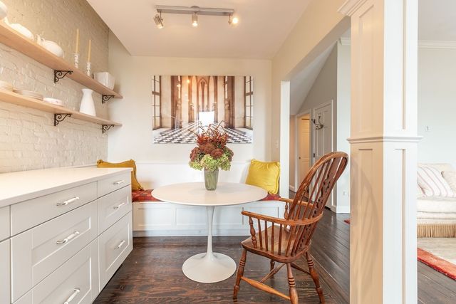 a dining room with furniture and wooden floor