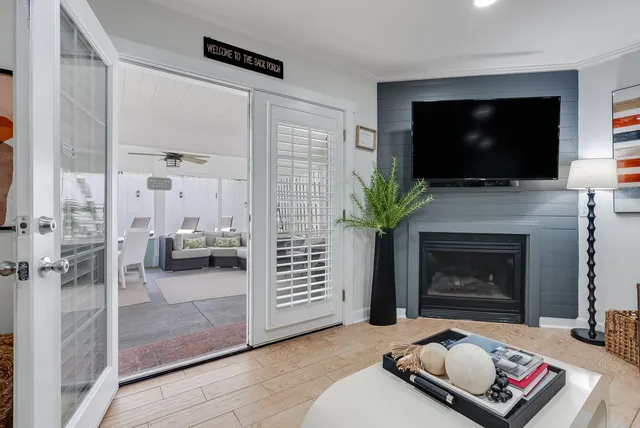 a living room with furniture a flat screen tv and a fireplace