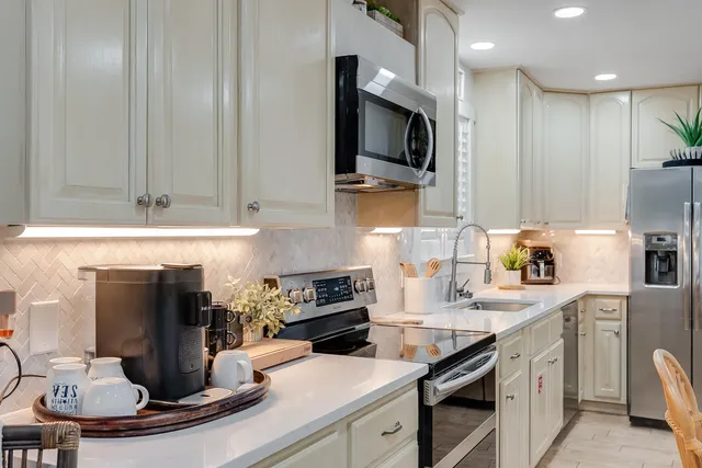 a kitchen with a sink a stove and cabinets