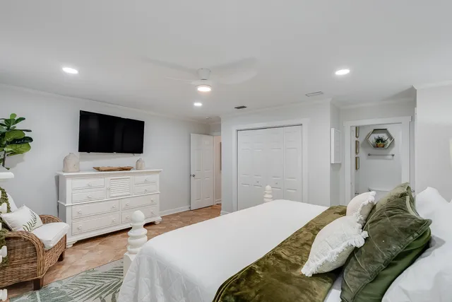 a bedroom with a bed and a flat screen tv