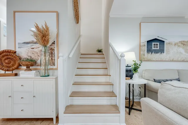a view of staircase with white walls and a potted plant