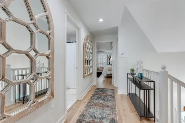 a room with two bed and a chandelier