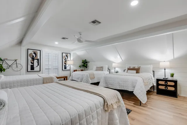 a spacious bedroom with two beds and a couch