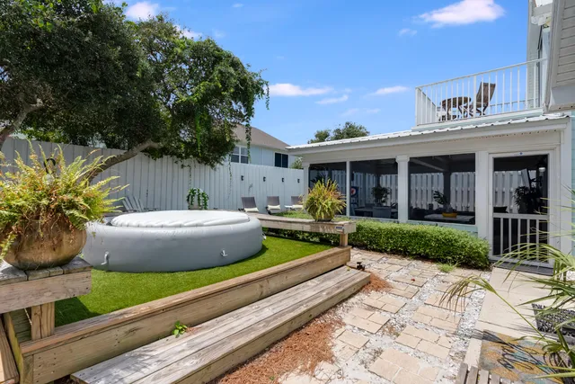 a backyard of a house with chairs and a fence